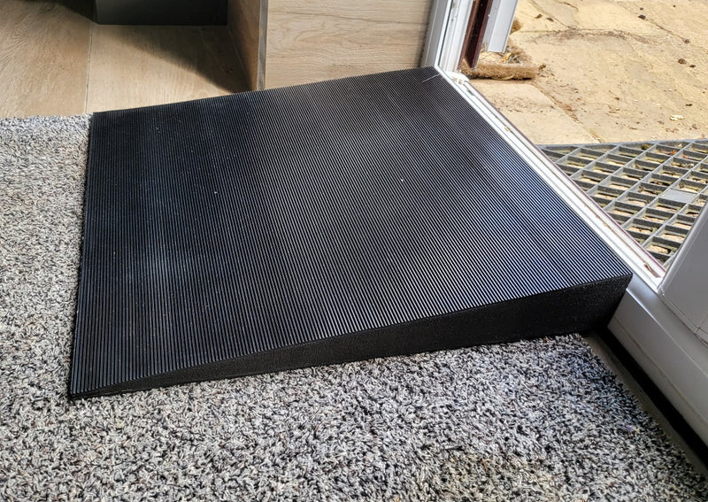 Side view of the threshold ramp designed to help arthritic dogs over raised thresholds