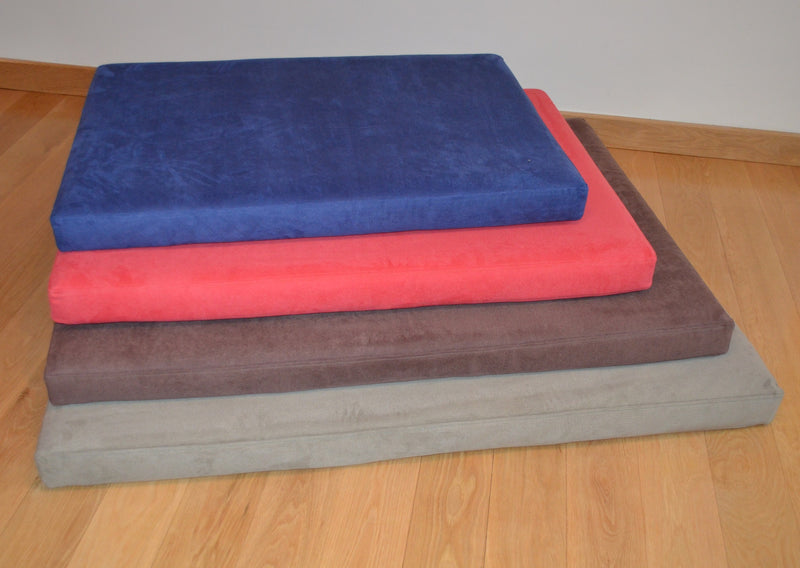 Pile of four different colours and sizes of Signature foam and memory foam dog beds from Big Dog Bed Company