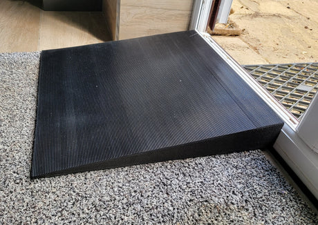 Side view of the threshold ramp designed to help arthritic dogs over raised thresholds